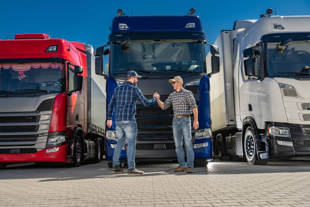 Freight business owners reviewing factoring options